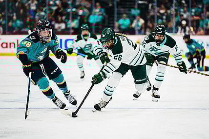 Boston Fleet forward Ella Huber breaks ahead with the puck as Sirens rookie Kristyna Kaltounkova defends.
