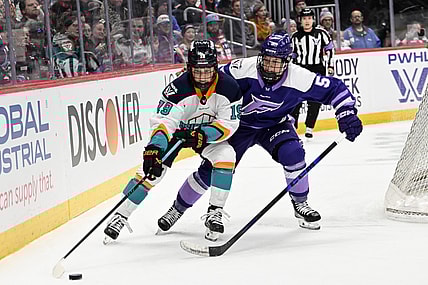 New York Sirens forward Paetyn Levis wards off Minnesota Frost defender Sidney Morin.