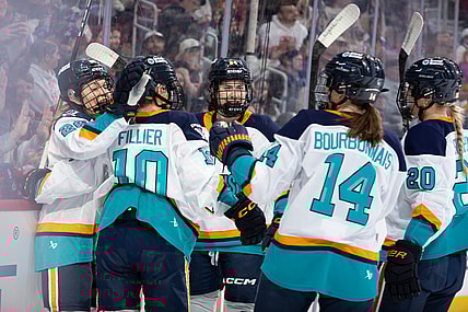 New York Sirens first-liners Casey O'Brien, Sarah Fillier, and Anne Cherkowski celebrate after all factoring into a goal against the Montreal Victoire.