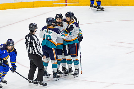 New York Sirens forwards Sarah Fillier and Casey O'Brien celebrate with defender Allyson Simpson, who scored the 1-0 overtime winner against the Toronto Sceptres.