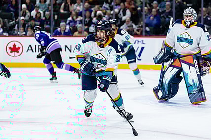 New York Sirens alternate captain Alex Carpenter skates in front of goalie Corinne Schroeder.