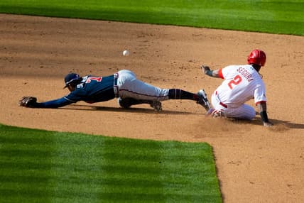 Apr 1, 2021; Philadelphia, Pennsylvania, USA; Atlanta Braves shortstop Dansby Swanson (7) is unable to field a throw as Philadelphia Phillies shortstop Jean Segura (2) slides safely into second base during the fourth inning at Citizens Bank Park. Mandatory Credit: Bill Streicher-USA TODAY Sports