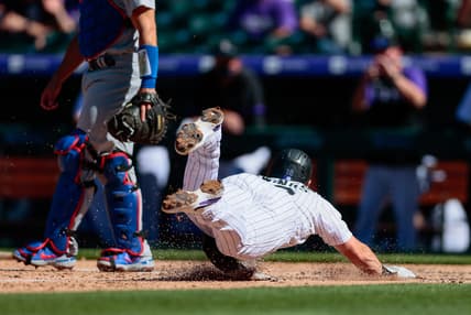 Apr 1, 2021; Denver, Colorado, USA; Colorado Rockies second baseman Chris Owings (12) slides into home for a run in the third inning against the Los Angeles Dodgers at Coors Field. Mandatory Credit: Isaiah J. Downing-USA TODAY Sports