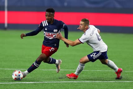 Apr 24, 2021; Foxborough, Massachusetts, USA; DC United midfielder Russell Canouse (6) defends New England Revolution midfielder Wilfrid Kaptoum (5) during the first half at Gillette Stadium. Mandatory Credit: Paul Rutherford-USA TODAY Sports