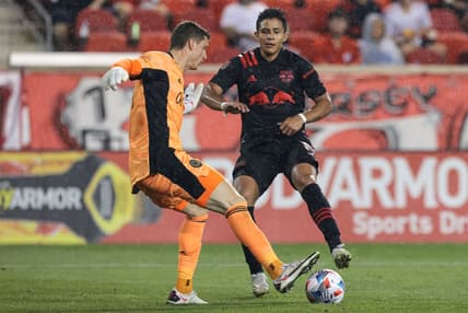 Jul 8, 2021; Harrison, New Jersey, USA; Philadelphia Union goalkeeper Matt Freese (1) plays the ball against New York Red Bulls midfielder Wikelman Carmona (19) during the second half at Red Bull Arena. Mandatory Credit: Vincent Carchietta-USA TODAY Sports