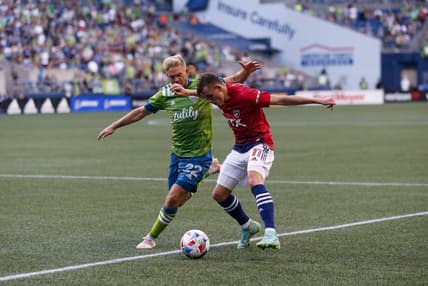 Aug 4, 2021; Seattle, Washington, USA; FC Dallas forward Szabolcs Schon (11) tries to get a shot off as Seattle Sounders FC midfielder Kelyn Rowe (22) defends during the first half at Lumen Field. Mandatory Credit: Jennifer Buchanan-USA TODAY Sports