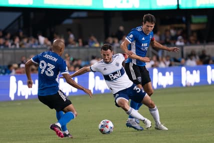 Aug 13, 2021; San Jose, California, USA; Vancouver Whitecaps midfielder Russell Teibert (31) fights for control of the ball against San Jose Earthquakes midfielder Judson (93) and defender Tanner Beason (15) during the first half at PayPal Park. Mandatory Credit: Stan Szeto-USA TODAY Sports