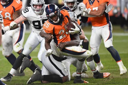 Jan 3, 2021; Denver, Colorado, USA; Denver Broncos running back Melvin Gordon (25) is tackled in the fourth quarter against the Las Vegas Raiders at Empower Field at Mile High. Mandatory Credit: Ron Chenoy-USA TODAY Sports