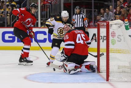 Nov 13, 2021; Newark, New Jersey, USA; New Jersey Devils goaltender Jonathan Bernier (45) makes a save while Boston Bruins center Brad Marchand (63) looks for the rebound during the first period at Prudential Center. Mandatory Credit: Ed Mulholland-USA TODAY Sports