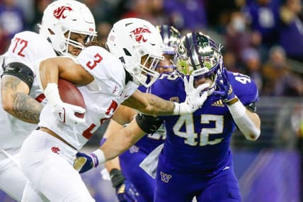 Nov 26, 2021; Seattle, Washington, USA; Washington State Cougars running back Deon McIntosh (3) and Washington Huskies linebacker Carson Bruener (42) during the first quarter at Alaska Airlines Field at Husky Stadium. Mandatory Credit: Joe Nicholson-USA TODAY Sports