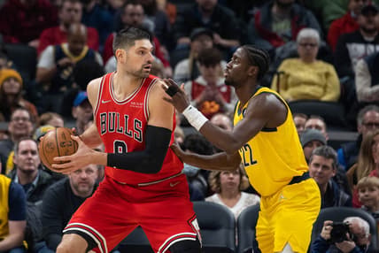 Feb 4, 2022; Indianapolis, Indiana, USA; Chicago Bulls center Nikola Vucevic (9) looks to dribble the ball while Indiana Pacers guard Caris LeVert (22) defends in the first half at Gainbridge Fieldhouse. Mandatory Credit: Trevor Ruszkowski-USA TODAY Sports