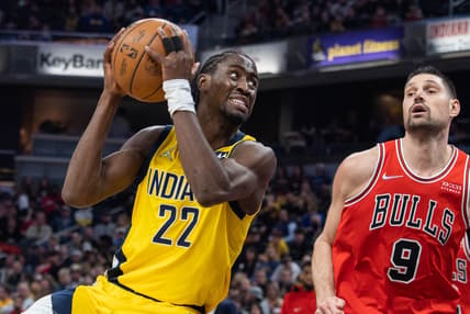Feb 4, 2022; Indianapolis, Indiana, USA; Indiana Pacers guard Caris LeVert (22) shoots the ball while Chicago Bulls center Nikola Vucevic (9) defends in the first half at Gainbridge Fieldhouse. Mandatory Credit: Trevor Ruszkowski-USA TODAY Sports