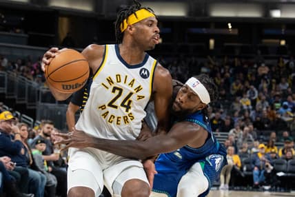 Feb 13, 2022; Indianapolis, Indiana, USA; Indiana Pacers guard Buddy Hield (24) dribbles the ball while Minnesota Timberwolves guard Patrick Beverley (22) defends in the second half at Gainbridge Fieldhouse. Mandatory Credit: Trevor Ruszkowski-USA TODAY Sports