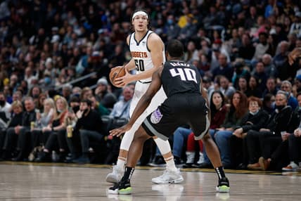 Feb 26, 2022; Denver, Colorado, USA; Denver Nuggets forward Aaron Gordon (50) controls the ball as Sacramento Kings forward Harrison Barnes (40) guards in the first quarter at Ball Arena. Mandatory Credit: Isaiah J. Downing-USA TODAY Sports