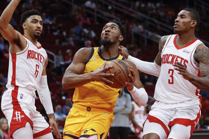 Mar 2, 2022; Houston, Texas, USA; Utah Jazz guard Donovan Mitchell (45) drives with the ball as Houston Rockets forward Kenyon Martin Jr. (6) and guard Kevin Porter Jr. (3) defend during the second quarter at Toyota Center. Mandatory Credit: Troy Taormina-USA TODAY Sports