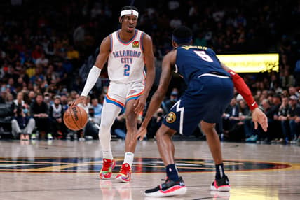 Mar 2, 2022; Denver, Colorado, USA; Oklahoma City Thunder guard Shai Gilgeous-Alexander (2) controls the ball as Denver Nuggets forward Will Barton (5) guards in the fourth quarter at Ball Arena. Mandatory Credit: Isaiah J. Downing-USA TODAY Sports