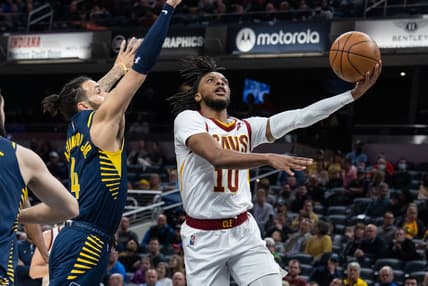 Mar 8, 2022; Indianapolis, Indiana, USA; Cleveland Cavaliers guard Darius Garland (10) shoots the ball while Indiana Pacers guard Duane Washington Jr. (4) defends in the first half at Gainbridge Fieldhouse. Mandatory Credit: Trevor Ruszkowski-USA TODAY Sports