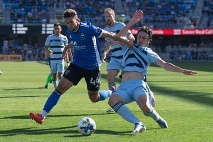May 22, 2022; San Jose, California, USA;  San Jose Earthquakes forward Cade Cowell (44) and Sporting Kansas City defender Ben Sweat (2) fight for control of the ball during the first half at PayPal Park. Mandatory Credit: Stan Szeto-USA TODAY Sports