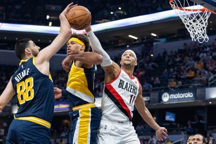 Mar 20, 2022; Indianapolis, Indiana, USA; Indiana Pacers center Goga Bitadze (88) and Portland Trail Blazers guard Josh Hart (11) fight for a rebound over Indiana Pacers forward Justin Anderson (10) in the first half at Gainbridge Fieldhouse. Mandatory Credit: Trevor Ruszkowski-USA TODAY Sports