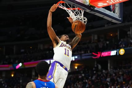 Apr 10, 2022; Denver, Colorado, USA; Los Angeles Lakers guard Malik Monk (11) finishes off a basket in the second half against the Denver Nuggets at Ball Arena. Mandatory Credit: Ron Chenoy-USA TODAY Sports