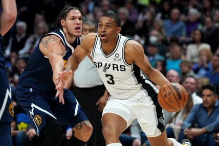 Apr 5, 2022; Denver, Colorado, USA; San Antonio Spurs forward Keldon Johnson (3) drives past Denver Nuggets forward Aaron Gordon (50) in the second half at Ball Arena. Mandatory Credit: Ron Chenoy-USA TODAY Sports