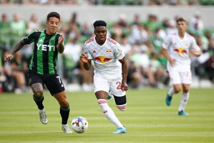 Jul 24, 2022; Austin, Texas, USA; New York Red Bulls forward Serge Ngoma (22) kicks the ball against Austin FC forward Sebastian Driussi (7) during the first half at Q2 Stadium. Mandatory Credit: Erich Schlegel-USA TODAY Sports