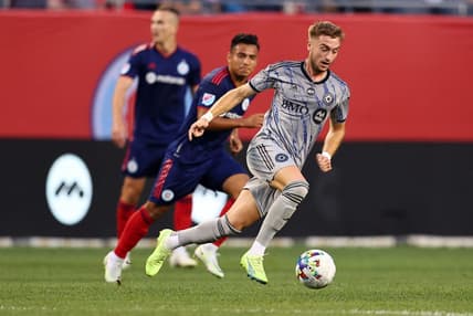 Aug 27, 2022; Chicago, Illinois, USA; CF Montreal midfielder Djordje Mihailovic (8) kicks the ball past Chicago Fire midfielder Jairo Torres (7) during the first half at Soldier Field. Mandatory Credit: Mike Dinovo-USA TODAY Sports