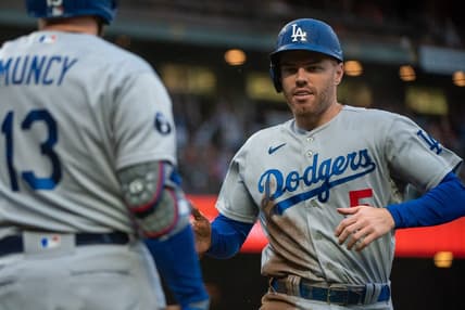 Sep 18, 2022; San Francisco, California, USA;  Los Angeles Dodgers first baseman Freddie Freeman (5) high fives third baseman Max Muncy (13) after scoring during the fourth inning against the San Francisco Giants at Oracle Park. Mandatory Credit: Ed Szczepanski-USA TODAY Sports