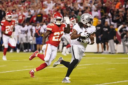Oct 10, 2022; Kansas City, Missouri, USA; Las Vegas Raiders wide receiver Davante Adams (17) runs the ball in for a touchdown pursued by Kansas City Chiefs cornerback Rashad Fenton (27) in the first half at GEHA Field at Arrowhead Stadium. Mandatory Credit: Jay Biggerstaff-USA TODAY Sports