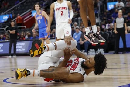 Oct 11, 2022; Detroit, Michigan, USA;  Detroit Pistons forward Marvin Bagley III (35) grabs his knee and Oklahoma City Thunder forward Jeremiah Robinson-Earl (50) dunks in the first half at Little Caesars Arena. Mandatory Credit: Rick Osentoski-USA TODAY Sports