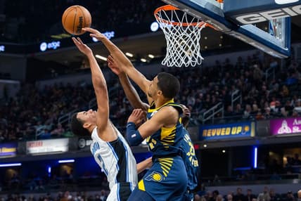 Nov 19, 2022; Indianapolis, Indiana, USA; Indiana Pacers guard Tyrese Haliburton (0) blocks a shot by Orlando Magic forward Caleb Houstan (2) in the second quarter at Gainbridge Fieldhouse. Mandatory Credit: Trevor Ruszkowski-USA TODAY Sports