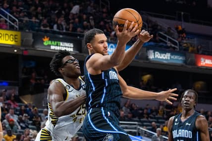 Nov 21, 2022; Indianapolis, Indiana, USA; Orlando Magic guard Jalen Suggs (4) rebounds the ball while Indiana Pacers forward Jalen Smith (25) defends in the first quarter at Gainbridge Fieldhouse. Mandatory Credit: Trevor Ruszkowski-USA TODAY Sports