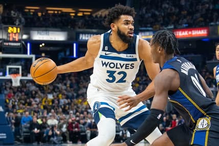 Nov 23, 2022; Indianapolis, Indiana, USA; Minnesota Timberwolves center Karl-Anthony Towns (32) dribbles the ball while Indiana Pacers guard Bennedict Mathurin (00) defends in the first quarter at Gainbridge Fieldhouse. Mandatory Credit: Trevor Ruszkowski-USA TODAY Sports