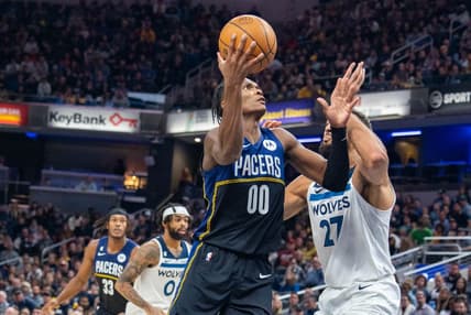 Nov 23, 2022; Indianapolis, Indiana, USA; Indiana Pacers guard Bennedict Mathurin (00) shoots the ball while Minnesota Timberwolves center Rudy Gobert (27) defends in the second half at Gainbridge Fieldhouse. Mandatory Credit: Trevor Ruszkowski-USA TODAY Sports
