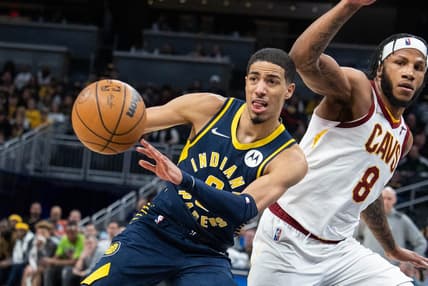 Mar 8, 2022; Indianapolis, Indiana, USA; Indiana Pacers guard Tyrese Haliburton (0) passes the ball while Cleveland Cavaliers forward Lamar Stevens (8) defends in the second half at Gainbridge Fieldhouse. Mandatory Credit: Trevor Ruszkowski-USA TODAY Sports