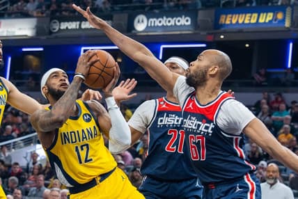 Dec 9, 2022; Indianapolis, Indiana, USA; Indiana Pacers forward Oshae Brissett (12) shoots the ball while Washington Wizards forward Taj Gibson (67) defends in the second quarter at Gainbridge Fieldhouse. Mandatory Credit: Trevor Ruszkowski-USA TODAY Sports
