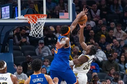 Dec 18, 2022; Indianapolis, Indiana, USA; Indiana Pacers guard Bennedict Mathurin (00) shoots the ball while New York Knicks center Mitchell Robinson (23) defends in the second quarter at Gainbridge Fieldhouse. Mandatory Credit: Trevor Ruszkowski-USA TODAY Sports