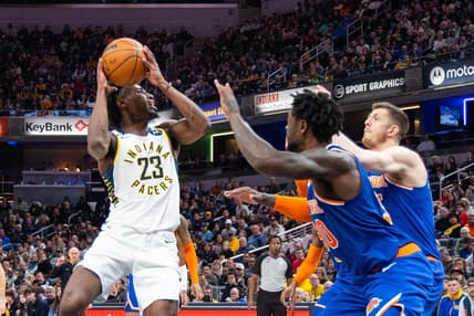 Dec 18, 2022; Indianapolis, Indiana, USA; Indiana Pacers forward Aaron Nesmith (23) shoots the ball while New York Knicks forward Julius Randle (30) defends in the second half at Gainbridge Fieldhouse. Mandatory Credit: Trevor Ruszkowski-USA TODAY Sports