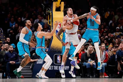 Dec 25, 2022; Denver, Colorado, USA; Denver Nuggets forward Aaron Gordon (50) battles for a rebound with Phoenix Suns guard Damion Lee (10) and guard Landry Shamet (14) as forward Ish Wainright (12) defends in the second quarter at Ball Arena. Mandatory Credit: Isaiah J. Downing-USA TODAY Sports