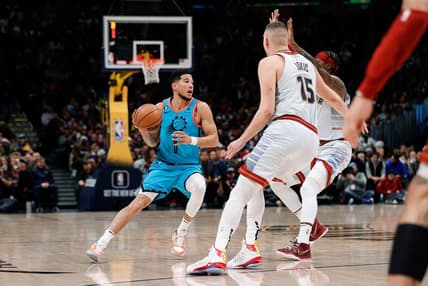 Dec 25, 2022; Denver, Colorado, USA; Phoenix Suns guard Devin Booker (1) controls the ball against Denver Nuggets center Nikola Jokic (15) and forward Zeke Nnaji (22) in the first quarter against the Phoenix Suns at Ball Arena. Mandatory Credit: Isaiah J. Downing-USA TODAY Sports
