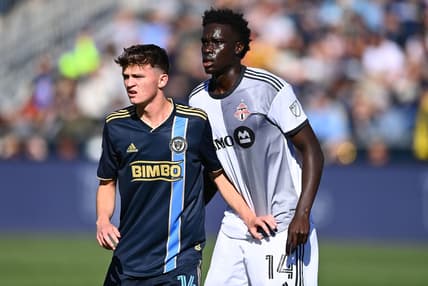 Oct 9, 2022; Philadelphia, Pennsylvania, USA; Philadelphia Union midfielder Jack Mcglynn (16) defends Toronto FC midfielder Noble Okello (14) in the first half at Subaru Park. Mandatory Credit: Kyle Ross-USA TODAY Sports