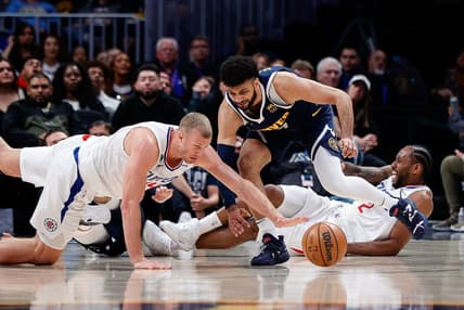 Feb 26, 2023; Denver, Colorado, USA; Los Angeles Clippers center Mason Plumlee (44) dives for the ball ahead of Denver Nuggets guard Jamal Murray (27) as forward Kawhi Leonard (2) reacts from the floor in the fourth quarter at Ball Arena. Mandatory Credit: Isaiah J. Downing-USA TODAY Sports