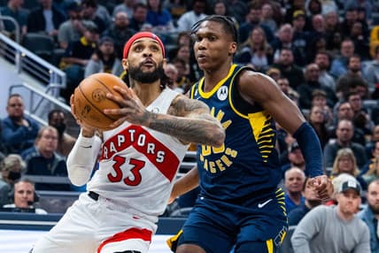 Jan 2, 2023; Indianapolis, Indiana, USA; Toronto Raptors guard Gary Trent Jr. (33) shoots the ball while Indiana Pacers guard Bennedict Mathurin (00) defends in the second half at Gainbridge Fieldhouse. Mandatory Credit: Trevor Ruszkowski-USA TODAY Sports