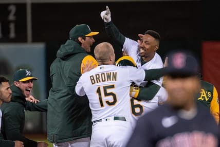 Apr 4, 2023; Oakland, California, USA; Oakland Athletics second baseman Tony Kemp (5) celebrates with team mates after hitting a game winning single during the ninth inning of the game against the Cleveland Guardians at RingCentral Coliseum. Mandatory Credit: Ed Szczepanski-USA TODAY Sports