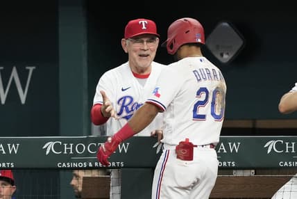 Apr 29, 2023; Arlington, Texas, USA; Texas Rangers shortstop Ezequiel Duran (20) celebrates his two-run home run with manager Bruce Bochy (15) against the New York Yankees during the fifth inning at Globe Life Field. Mandatory Credit: Jim Cowsert-USA TODAY Sports