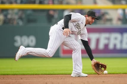 May 23, 2023; Denver, Colorado, USA; Colorado Rockies second baseman Ryan McMahon (24) fields the ball in the first inning against the Miami Marlins at Coors Field. Mandatory Credit: Ron Chenoy-USA TODAY Sports