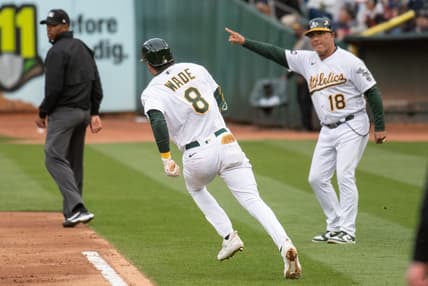 Jun 27, 2023; Oakland, California, USA; Oakland Athletics first base coach Mike Aldrete (18) directs left fielder Tyler Wade (8) to advance to second base during the third inning against the New York Yankees at Oakland-Alameda County Coliseum. Mandatory Credit: Ed Szczepanski-USA TODAY Sports