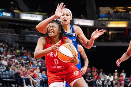 May 19, 2023; Indianapolis, Indiana, USA; Indiana Fever guard Kelsey Mitchell (0) shoots the ball while Connecticut Sun center Brionna Jones (42) defends in the second half at Gainbridge Fieldhouse. Mandatory Credit: Trevor Ruszkowski-USA TODAY Sports
