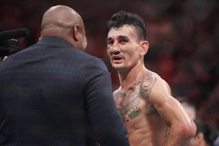 Apr 15, 2023; Kansas City, Missouri, USA; Max Holloway (red gloves) reacts after the fight against Arnold Allen (blue gloves) during UFC Fight Night at T-Mobile Center. Mandatory Credit: Denny Medley-USA TODAY Sports