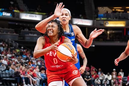 May 19, 2023; Indianapolis, Indiana, USA; Indiana Fever guard Kelsey Mitchell (0) shoots the ball while Connecticut Sun center Brionna Jones (42) defends in the second half at Gainbridge Fieldhouse. Mandatory Credit: Trevor Ruszkowski-USA TODAY Sports